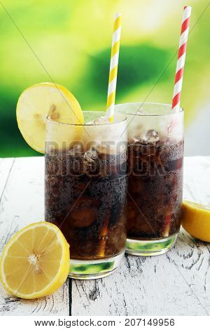 Softdrink With Ice Cubes, Lemon And Straw In Glass