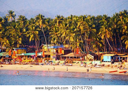 Palolem beach, South Goa, India. One of the best beaches in Goa. Colorful beach huts and palm trees on the coast. Luxury leisure.