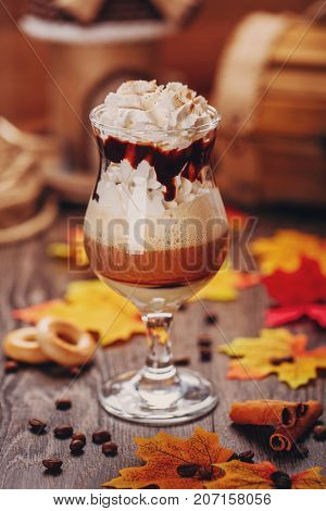 Creamy dessert. Smoothies. Autumn Desser. Cream dessert. Smoothies. Decoration of dry autumn leaves and coffee beans. Coffee cocktail.