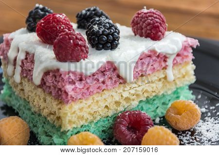 Cake with raspberry and blueberry on the plate