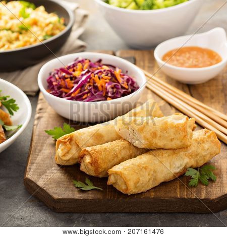 Egg rolls with cabbage, chicken, rice and cole slaw, asian food concept