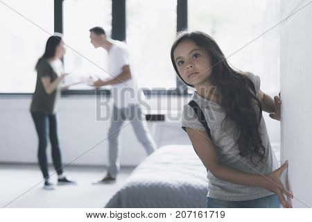 A Man And A Woman Swear In The Room. The Dark-haired Girl Tries To Escape Imperceptibly From The Apa