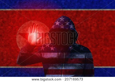 An american flag hooded hacker touching the flag of north korea with computercode texture cyberattack concept