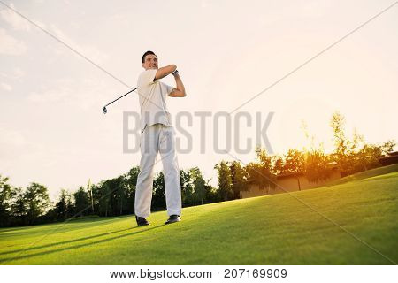 Great Blow. A Man In A White Suit Plays Golf. He Is Pleased With His Blow