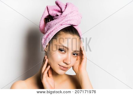 girl with a towel on her head feels the contours of her face