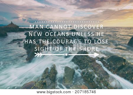 Inspirational and motivational quotes - Man cannot discover new oceans unless he had the courage to lose sight of the shore. Retro styles and blurry background.