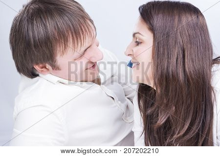 Family Relationships Concepts. Young Caucasian Family Communicating Together on Floor. Smiling and Embracing Each Other.Horizontal Image Orientation