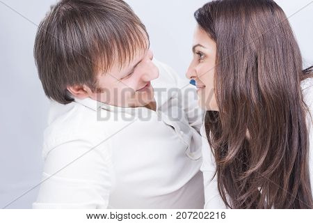 Family Relationships Concepts. Young Caucasian Family Communicating Together on Floor. Smiling and Embracing Each Other.Horizontal Image Composition