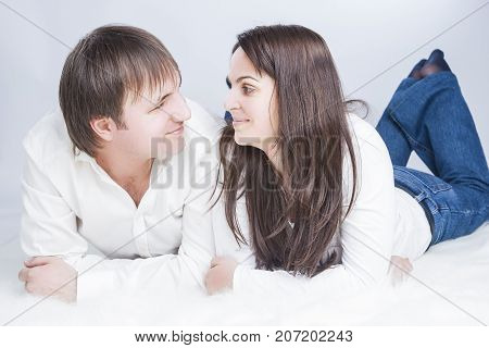 Family Ideas. Happy and Positive Caucasian Couple Having Time Together. communicating on Floor with Each Other While Looking Eyes To Eyes. Horizontal Image Orientation