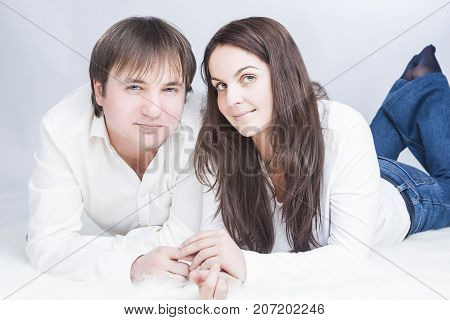Family Ideas. Happy and Positive Caucasian Couple Having Time Together. communicating on Floor with Each Other While Looking Eyes To Eyes and Holding Hands In Touch. Horizontal Image