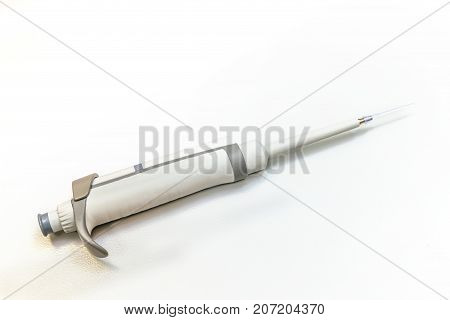 Automatic pipette dispenser on white laboratory table
