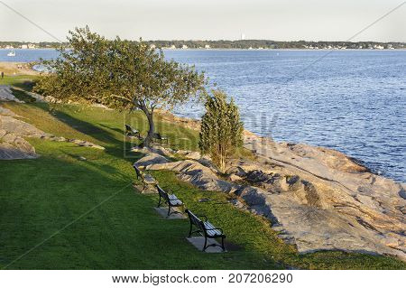 Early autumn evening overlooking rocky shoreline at Fort Phoenix in Fairhaven Massachusetts