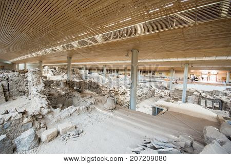 Santorini, Greece - April 20, 2017: Akrotiri is an archeological site from the Minoan Bronze Age on the Greek island of Santorini (Thera). Photo of recovered ancient buildings and decorated pottery.
