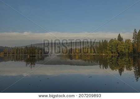 Blue morning near Kladska pond in autumn time with fog