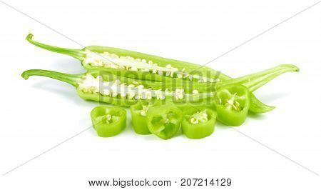 A pile chopped chilli peppers on a white background sliced green bell pepper