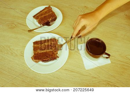 Coffee cup and chocolate cake onon wooden table. Coffee and a piece of cake - Retro color