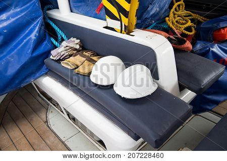 Gloves and helmets on grey seat background in boca de valeria brazil. Construction industry professional workwear and equipment. Safety and protection concept.