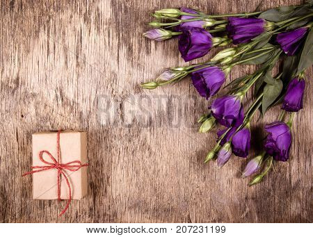 Gift box and bouquet of flowers. Purple flowers. Eustoma. Copy space