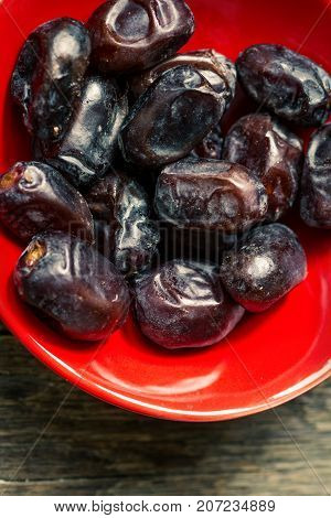 Fresh sweet dates on wooden background, close up