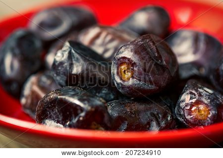 Fresh sweet dates on wooden background, close up