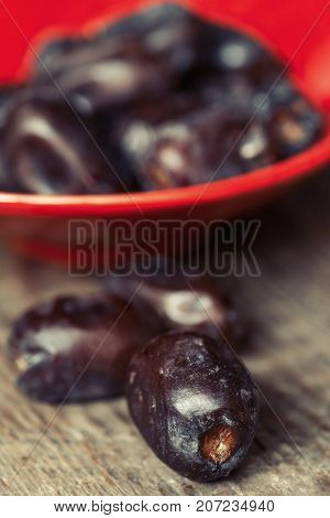 Fresh sweet dates on wooden background, close up