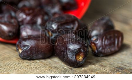 Fresh sweet dates on wooden background, close up