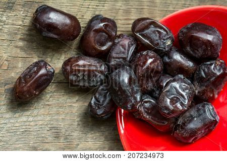 Fresh sweet dates on wooden background, close up