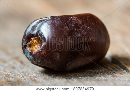 Fresh sweet dates on wooden background, close up