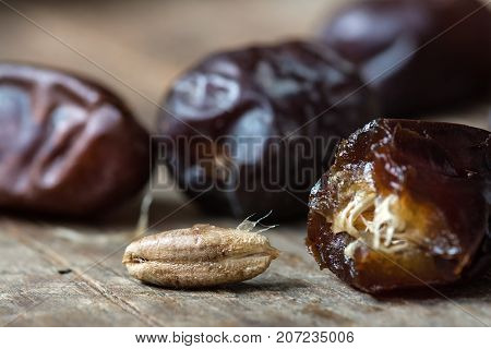 Fresh sweet dates on wooden background, close up