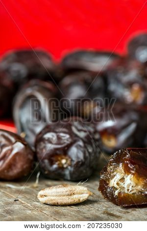 Fresh sweet dates on wooden background, close up