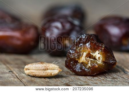 Fresh sweet dates on wooden background, close up