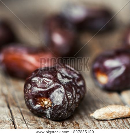 Fresh sweet dates on wooden background, close up