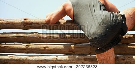 Mud race runners participant overcome obstacles extreme sport
