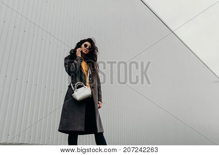 Young Elegant Girl Posing At City Street. Pretty Beautiful Business Woman In Elegant Gray Coat Again