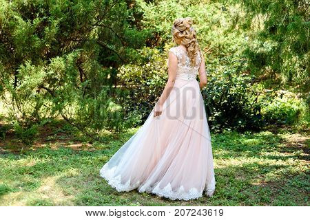 Beautiful Bride In Wedding Dress Spinning In The Park Outdoor. Dress Developing In Wind. Happy Bride