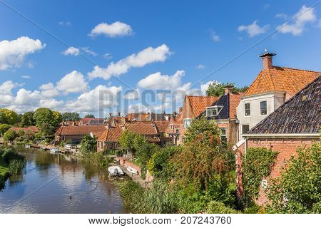 Old houses and river in the village of Winsum Netherlands