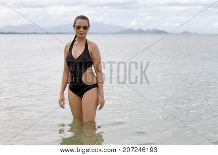 Woman show shape big and bikini on beach at Ban Krut Beach Prachuap Khirikhan Province Thailand