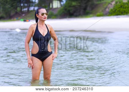 Woman with black bikini show sexy on beach at Ban Krut Beach Prachuap Khirikhan Province Thailand