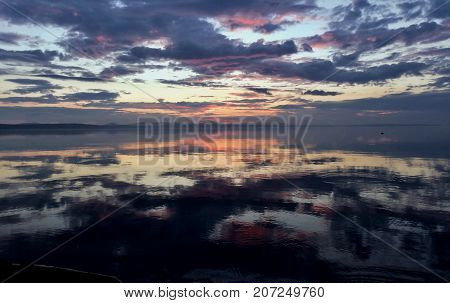 Colorful Sky Reflected In A Lake At Sunset