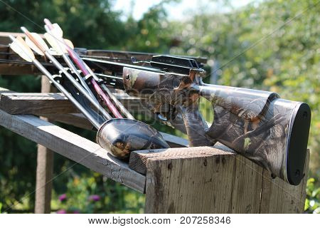 Crossbow, weapons producing boom.crossbow resting on tree trunk in autumn woods