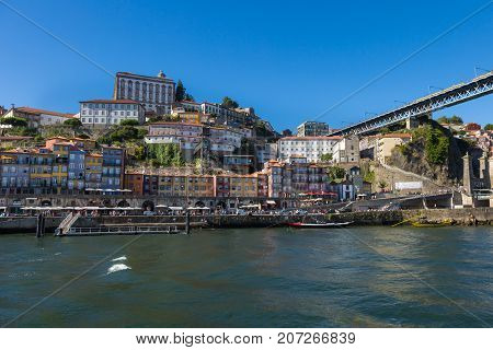 Old Town Skyline from Across the Douro River: Typical Colorful Facades and Rabelo Boats - Porto Portugal