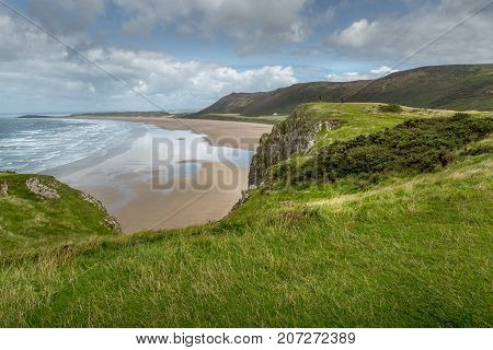 A landscape view of Rhossili Bay on the Gower Peninsula Swansea South Wales UK
