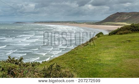 A landscape view of Rhossili Bay on the Gower Peninsula Swansea South Wales UK