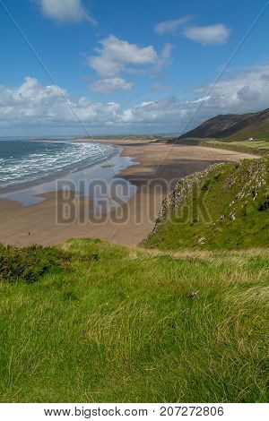 A landscape view of Rhossili Bay on the Gower Peninsula Swansea South Wales UK