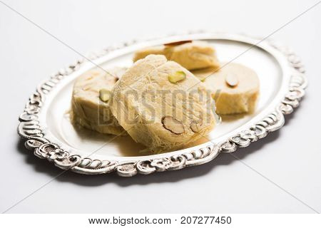 Stock photo of Soan Papdi or Soan roll or Patisa or patisha, popular sweet from India. selective focus