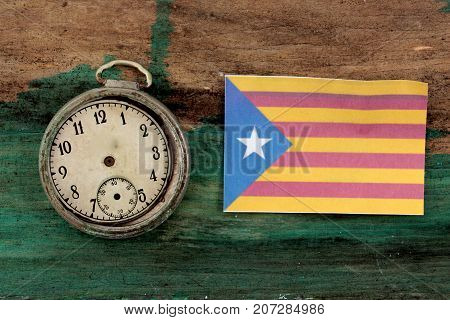 Old Clock And Flag Of Catalonia On Wood Background
