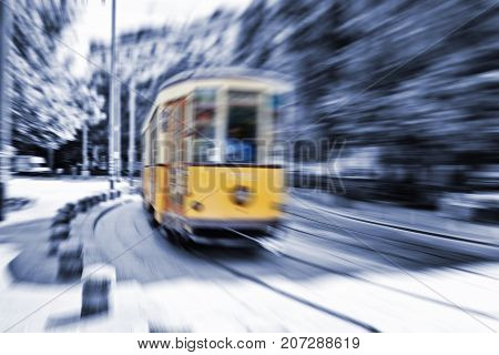 Blurred movement of a Old vintage orange tram in Milan Italy