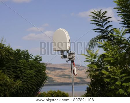 Cellular radio transmitter by lake in the countryside