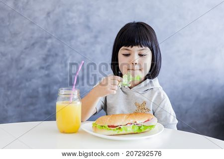 Cuttle Black Hair Little Girl Having Breakfast And Eat Lettuce