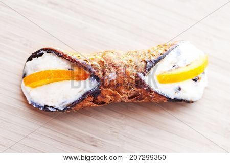 Sicilian Cannoli close up on wooden background traditional italian dessert with ricotta cheese. Fresh Canolli macro